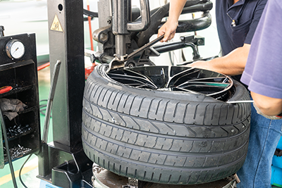 Worker chaning a tire in a garage